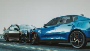 Two cars, one silver and one blue, are shown after a head-on collision on a road. A person stands in the background near a guardrail.